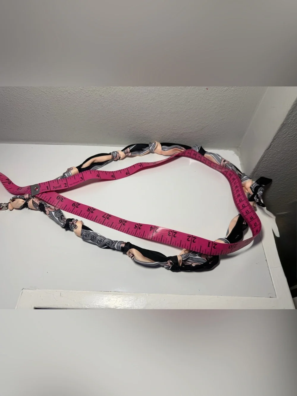 Silk-Twilly Pink and Black tied onto a leather lanyard holder/cell phone cord.